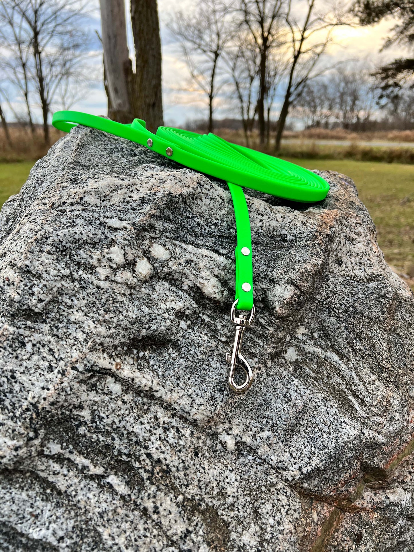 A durable neon green biothane dog long lead with contrasting nickel plated hardware, designed for strength and style, ideal for everyday use and outdoor adventures. Great for training recall and the beginning steps of off leash dog training.