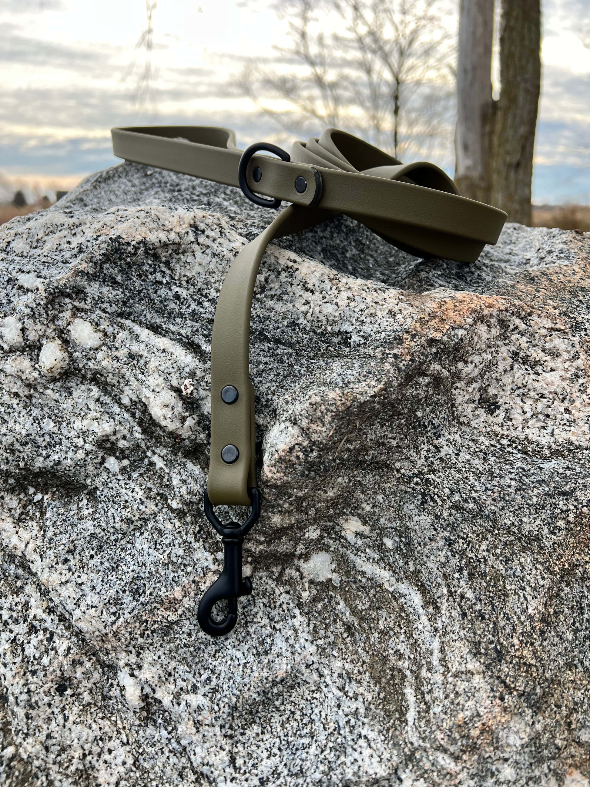 A durable olive drab biothane dog leash with contrasting black hardware, designed for strength and style, ideal for everyday use and outdoor adventures.