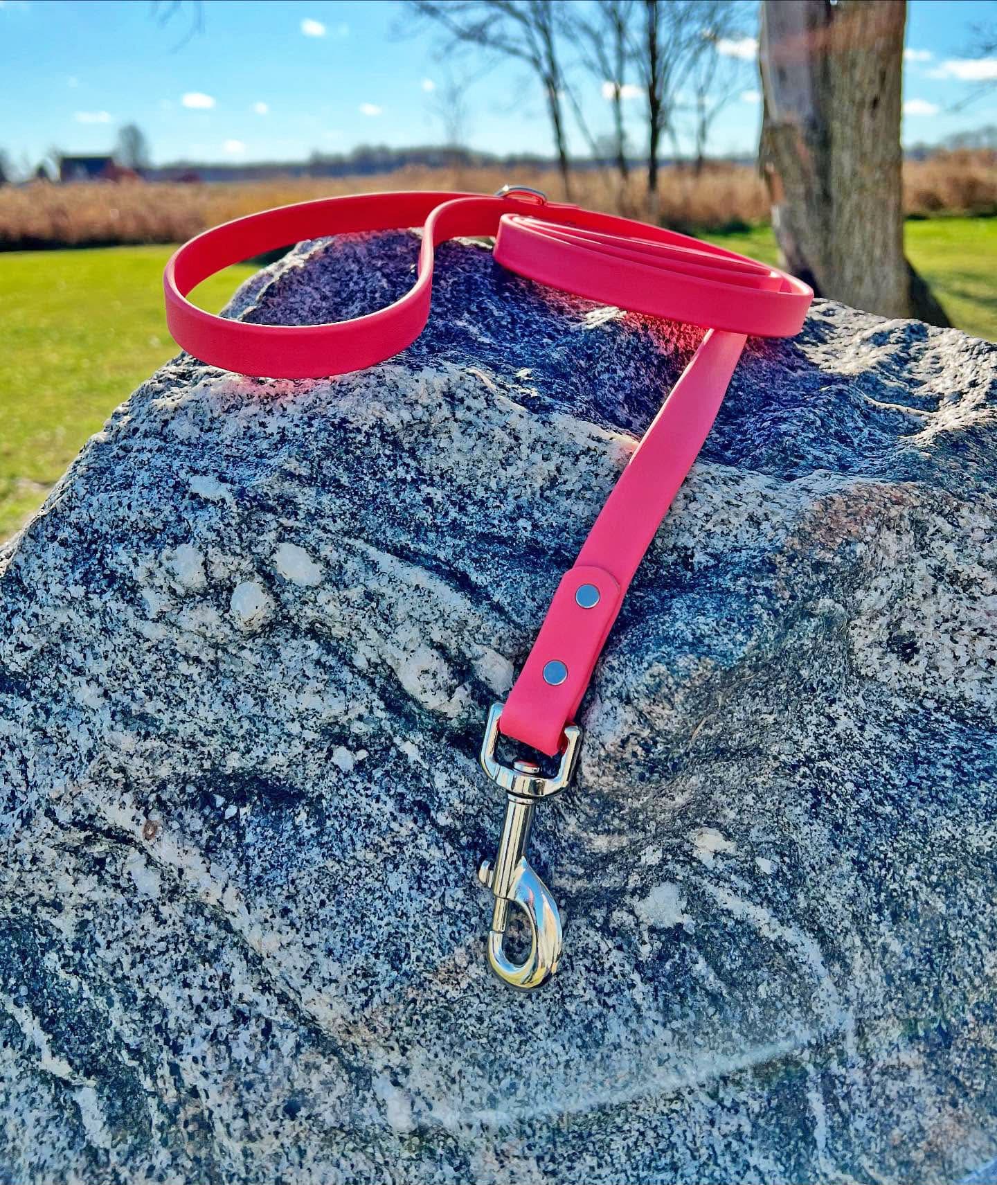 A durable pink coral biothane dog leash with contrasting nickel plated hardware, designed for strength and style, ideal for everyday use and outdoor adventures.